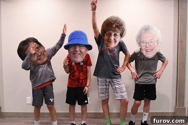 Grandkids performing a bobblehead skit, wearing oversized cutout faces of family members.