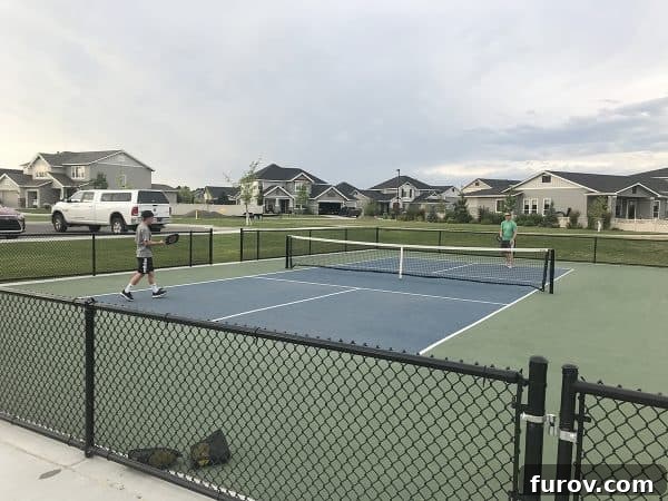 A family playing pickleball on an outdoor court, enjoying the game together.