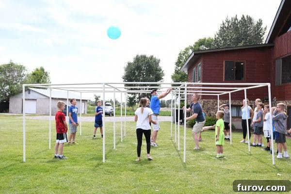 Children playing Nine Square, an outdoor game, with an adult supervising.