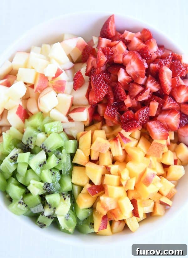 Vibrant Fruit Salsa with Cinnamon Sugar Crisps 4 White bowl with diced apples, kiwis, peaches and strawberries.