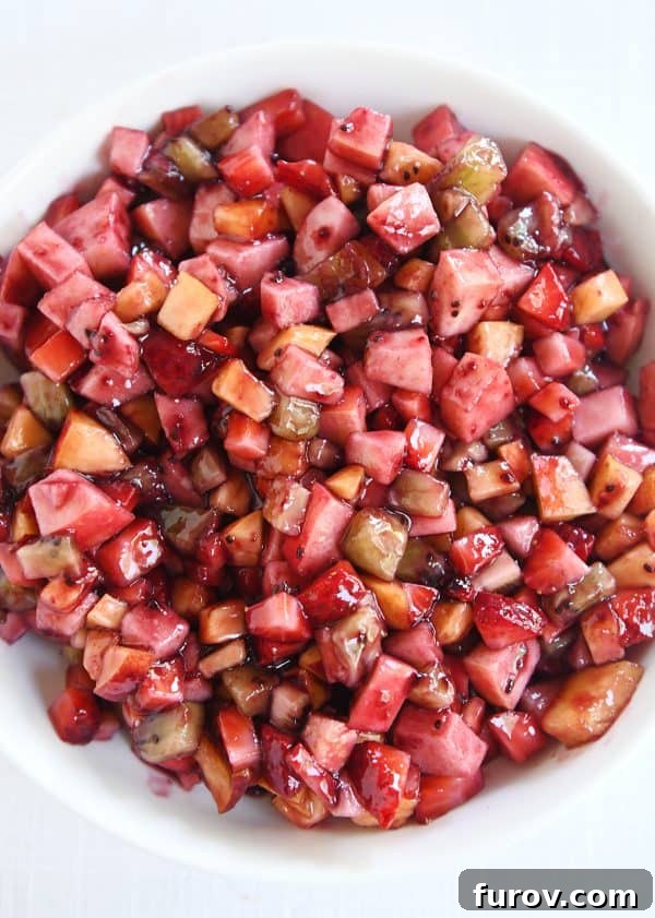 Vibrant Fruit Salsa with Cinnamon Sugar Crisps 5 Top down view of white shallow bowl with mixed fruit salsa.