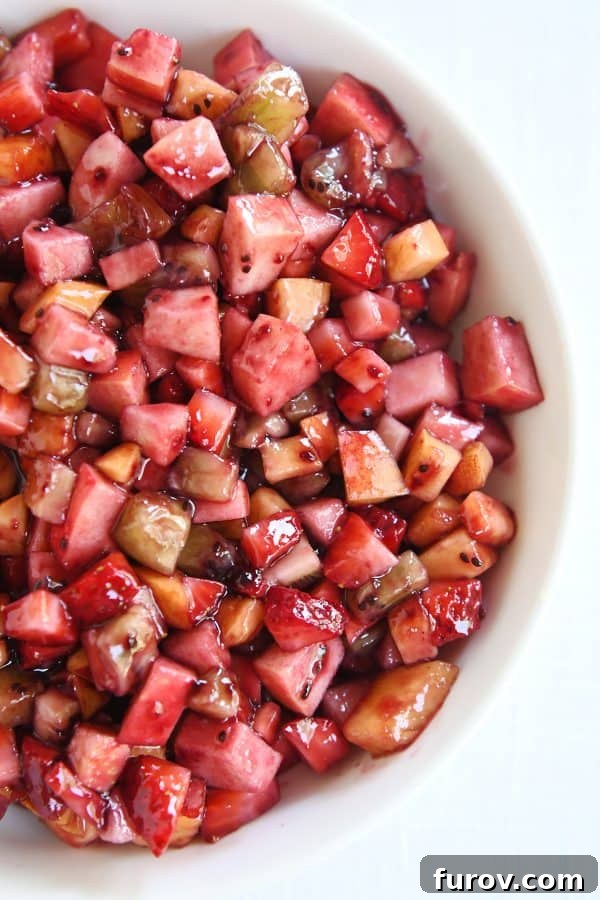 Vibrant Fruit Salsa with Cinnamon Sugar Crisps 7 Top down view of white shallow bowl with mixed fruit salsa.