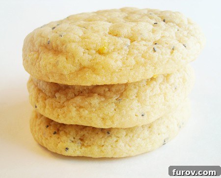 Stack of lemon poppy seed cookies on a white plate, ready to be enjoyed.