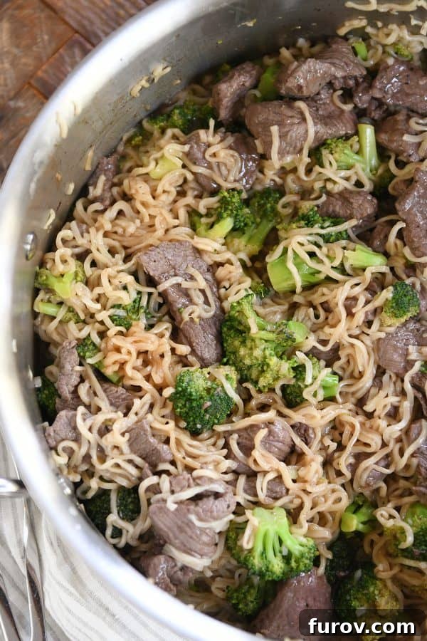 Effortless Beef and Broccoli Ramen Skillet 4 Top down view of beef and broccoli ramen noodles in pot. A full pot of delicious, steaming one-pot ramen noodles.