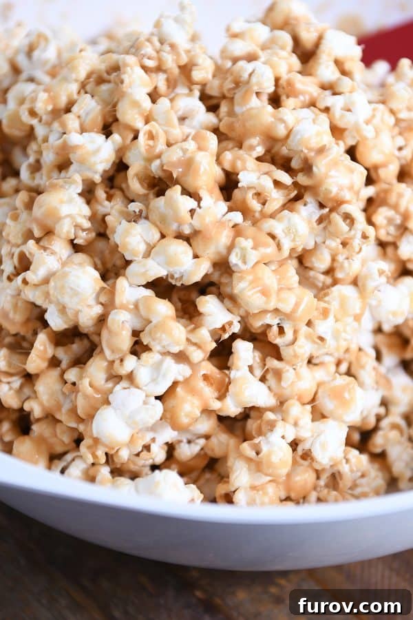 Gooey Peanut Butter Popcorn 2 A pristine white bowl brimming with the irresistible soft and chewy peanut butter caramel popcorn, perfectly coated and ready to be enjoyed.