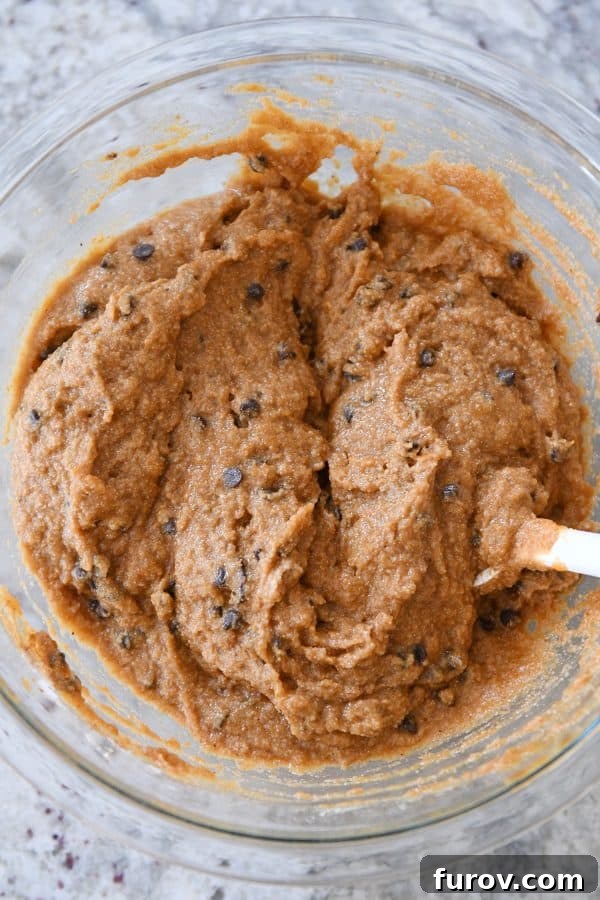 The smooth, mixed batter for pumpkin chocolate chip snack cake in a large mixing bowl, ready for the baking pan.
