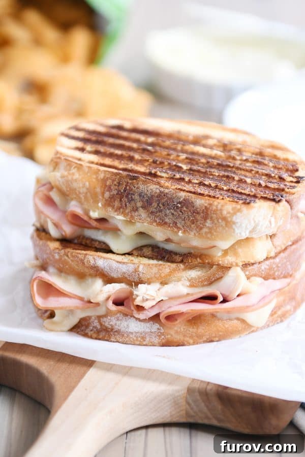 Two golden-brown Chicken Cordon Bleu Panini sandwiches, perfectly stacked and ready to serve.