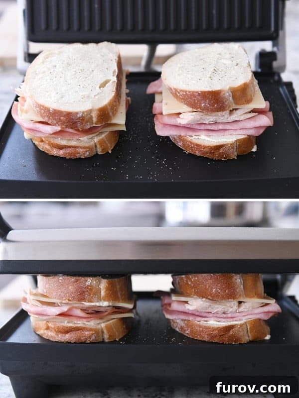 A delicious Chicken Cordon Bleu Panini cooking on a panini press, achieving a perfectly golden and crispy crust.