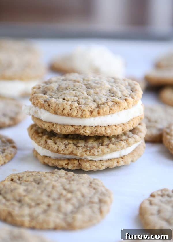 Two homemade oatmeal cream pies stacked on each other, revealing the creamy filling.