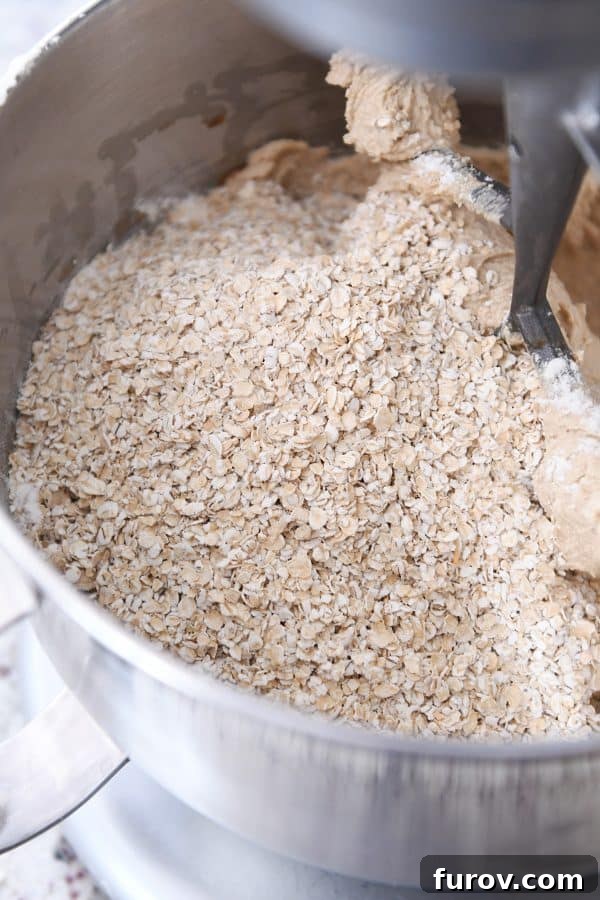 Stand mixer with quick oats added to the homemade oatmeal cream pies batter, showcasing the texture.