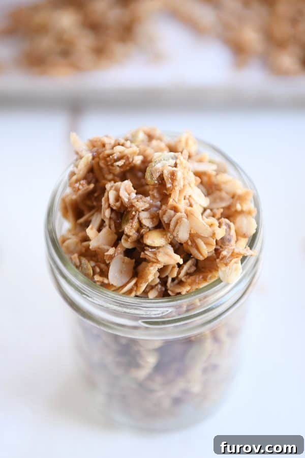 Glass jar filled with brown butter pecan granola.