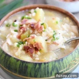 Green bowl filled with pressure cooker chicken corn chowder with bacon on top and spoon in the side.