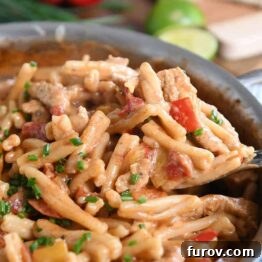 Scooping out spoonful of skillet chicken fajita pasta.