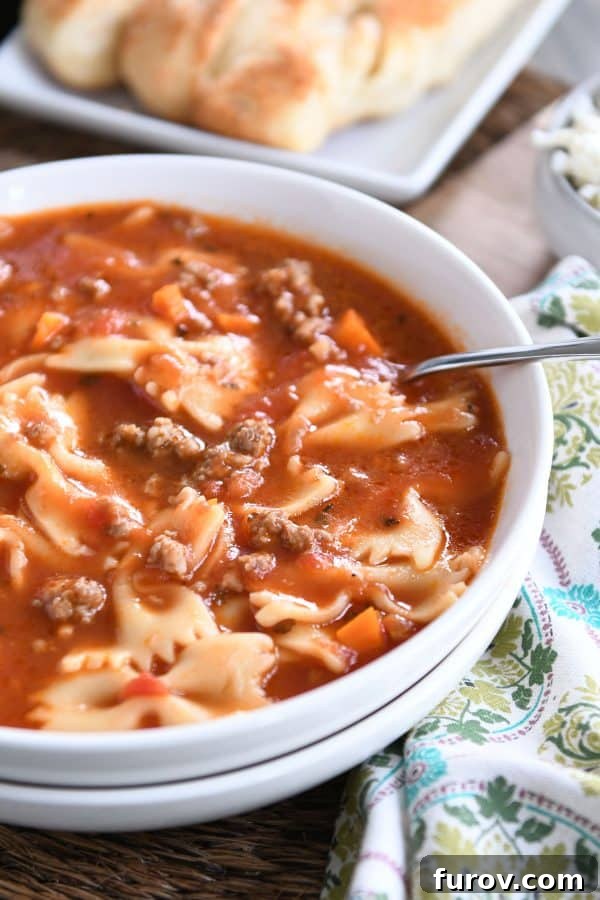 Homemade Lasagna Soup Pressure Cooker or Stovetop 7 A pristine white bowl filled with the comforting embrace of pressure cooker lasagna soup, ready to be enjoyed.