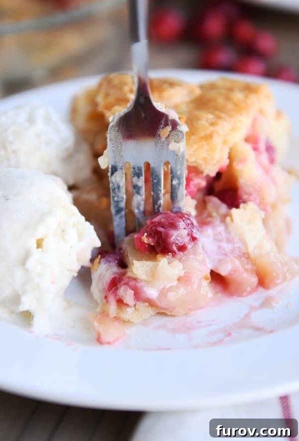 My Favorite Thanksgiving Apple Cranberry Pie 4 Slice of apple cranberry pie on white plate with ice cream.