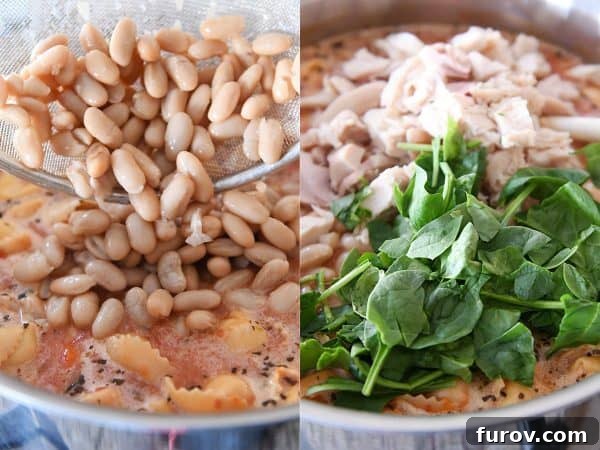 Cooked chicken, white beans, and fresh spinach are carefully added to the pot of simmering Tuscan tortellini soup, completing the dish.