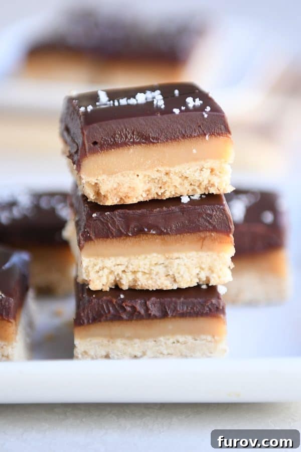 Homemade Dulce de Leche Caramel Shortbread Bars 3 Three homemade grown up Twix bars stacked on each other, showing the distinct layers.