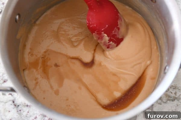 Homemade Dulce de Leche Caramel Shortbread Bars 9 Stirring vanilla into homemade caramel, ensuring it's well incorporated.