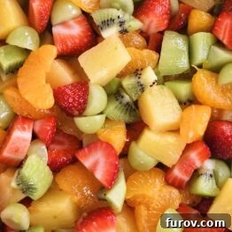 Zesty Honey Lime Fruit Medley 7 Closeup of vibrant honey lime fruit salad, showing the fresh fruit coated in a light, sweet, and zesty dressing.
