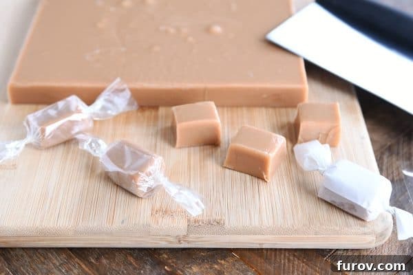 A selection of homemade caramels, some cut into squares and others neatly wrapped, showcasing the final delicious product.