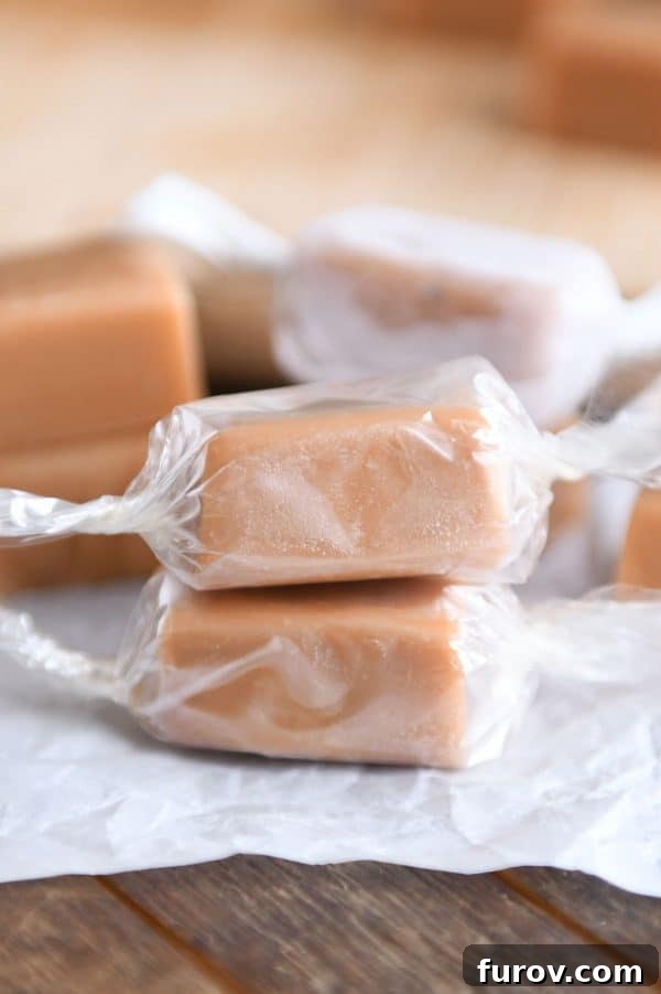 Neatly wrapped homemade caramels stacked artfully, ready to be enjoyed or gifted.