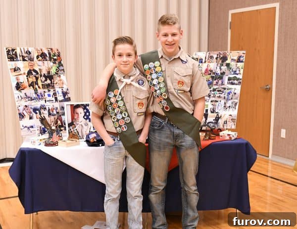 A young man in an Eagle Scout uniform receiving an award at a ceremony.