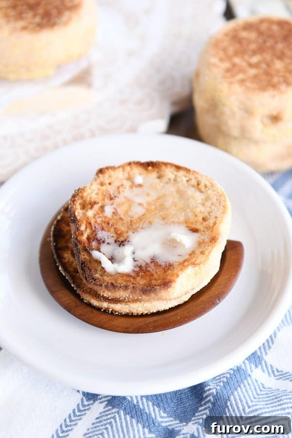 Simple Homemade English Muffins No Mixer Whole Grain 19 Homemade english muffin split open and toasted with butter.