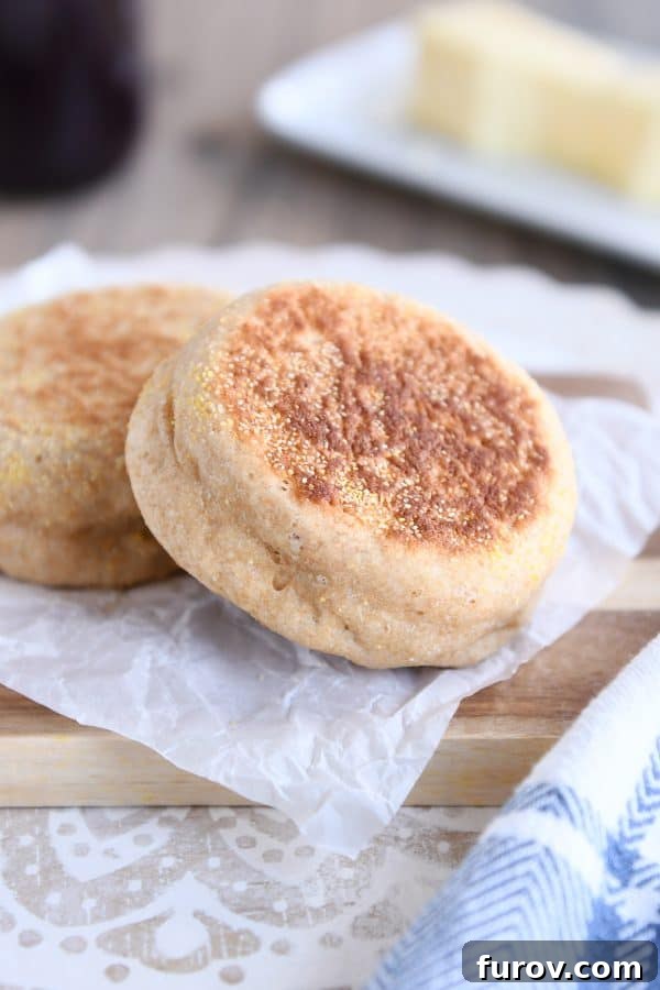 Simple Homemade English Muffins No Mixer Whole Grain 3 Easy homemade english muffins on parchment paper.