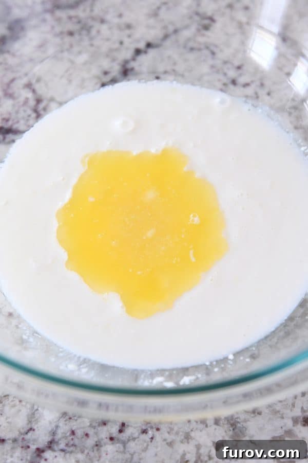 Simple Homemade English Muffins No Mixer Whole Grain 6 Adding butter to buttermilk for english muffin batter.