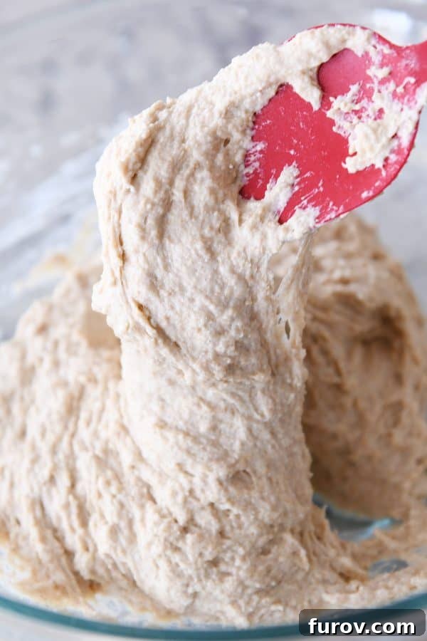Simple Homemade English Muffins No Mixer Whole Grain 9 Wet english muffin dough in glass bowl.