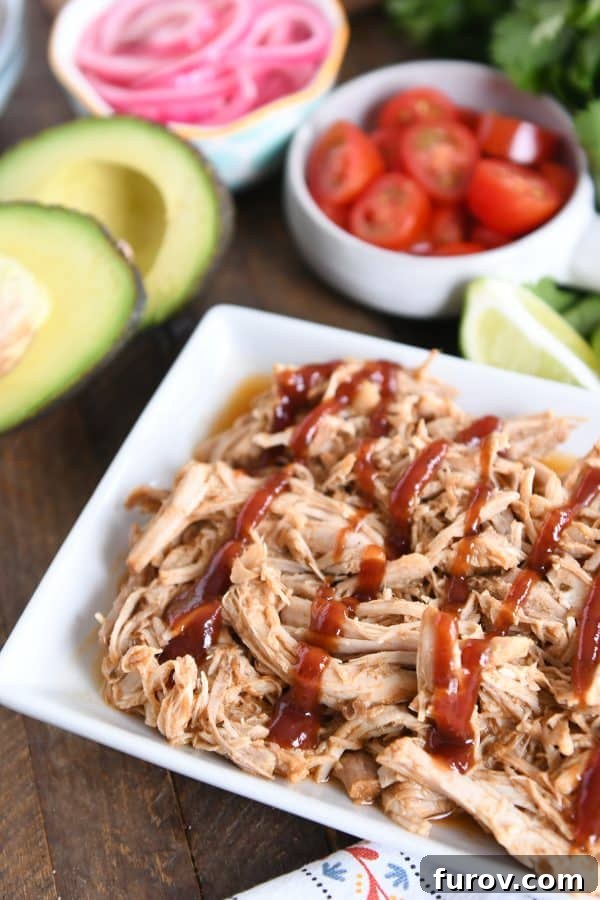 Ultimate Instant Pot BBQ Pork Tacos 3 Close-up of perfectly shredded BBQ pork, glistening with savory barbecue sauce, ready for serving.