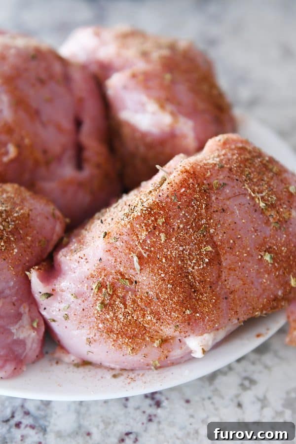 Ultimate Instant Pot BBQ Pork Tacos 5 Large chunks of pork roast meticulously rubbed with a fragrant spice blend, arranged on a cutting board.