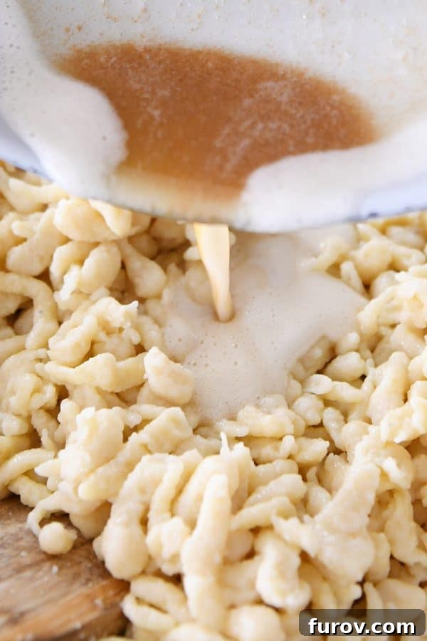 Whip Up Perfect German Spaetzle Quick Video Guide 12 Pouring browned butter over homemade German spaetzle.