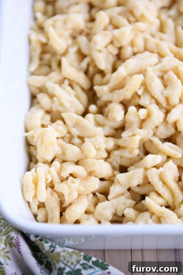 Whip Up Perfect German Spaetzle Quick Video Guide 3 Homemade German spaetzle noodles in white dish.
