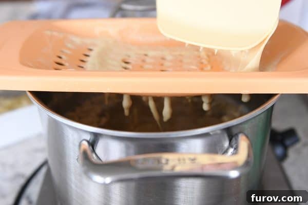 Whip Up Perfect German Spaetzle Quick Video Guide 9 Cooking homemade spaetzle in broth.