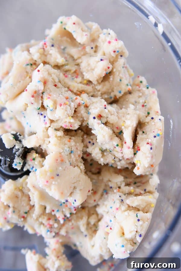 Perfectly mixed shortbread dough for funfetti bites, showcasing its smooth texture before chilling.