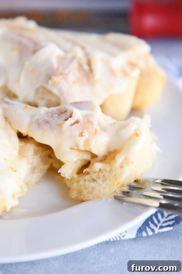 Perfected Homemade Orange Sweet Rolls 2 A delicious bite of a homemade orange sweet roll, showcasing its soft texture and vibrant filling.