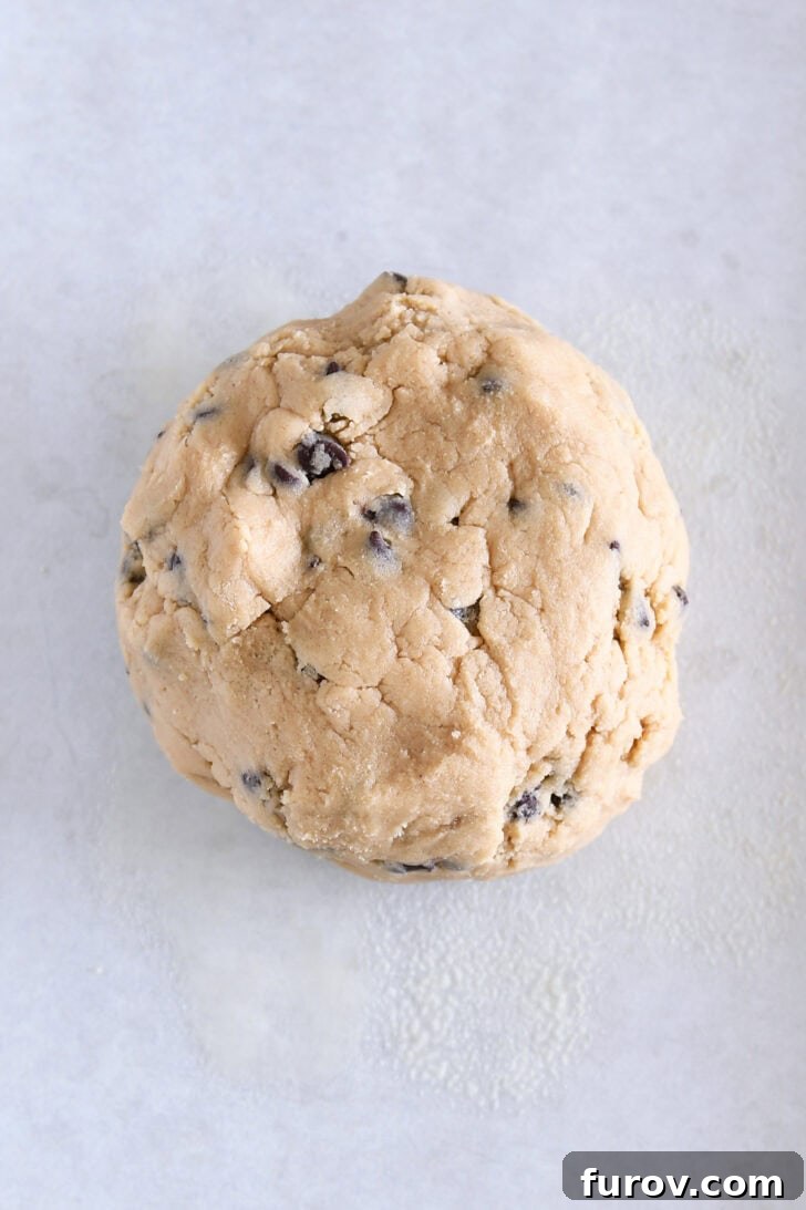 Top-down view of a large ball of raw chocolate chip cookie dough.