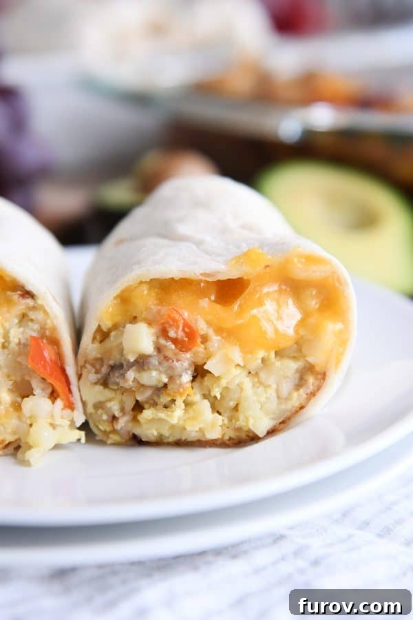 Easy freezer breakfast burrito cut in half on white plate.
