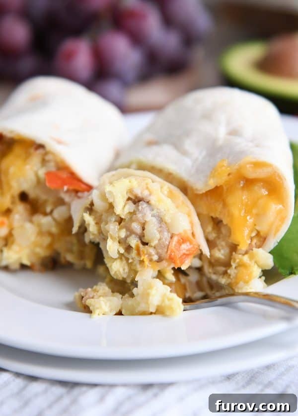 Easy freezer breakfast burrito cut in half with bite on fork.