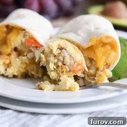 easy freezer breakfast burrito cut in half with bite on fork on white plate