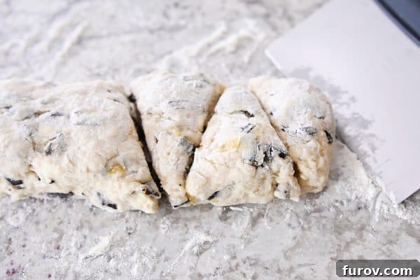 Decadent Chocolate Chip Banana Bread Scones 7 Cutting scone dough into triangles.