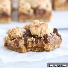 A bite taken out of a caramel peanut butter cookie bar