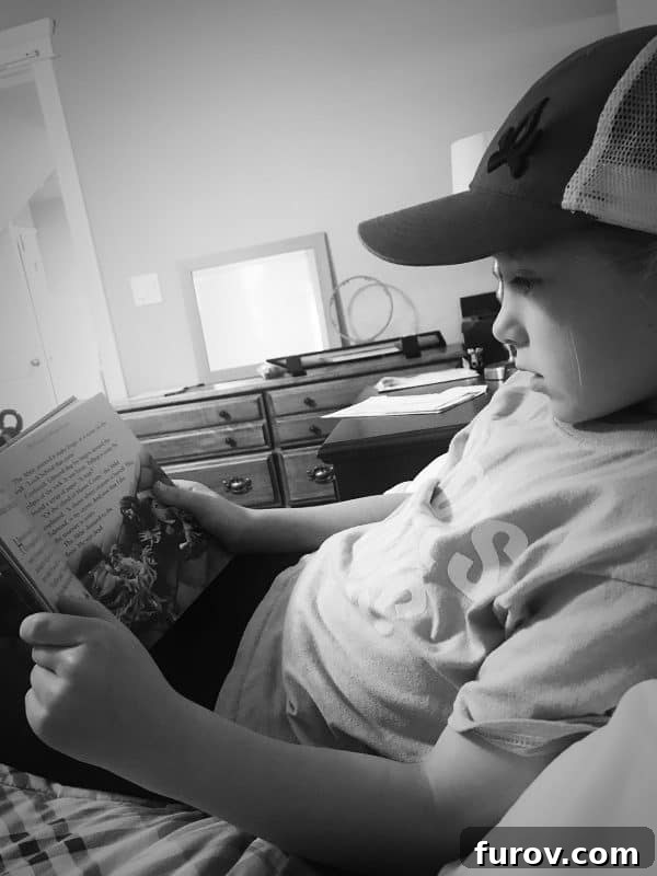 Young girl reading a book on a bed, providing comfort during a parent's recovery, a sweet moment of family support