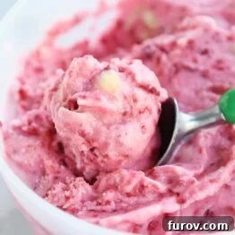 scooping out pink sorbet with ice cream sorbet