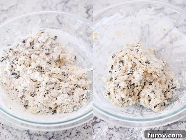 Mixing chocolate chunk biscuit dough in glass bowl.