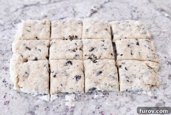 Cutting chocolate chunk biscuits into squares.