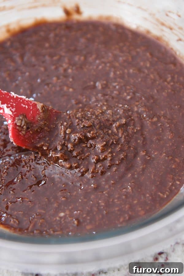 Irresistible No-Bake Peanut Butter Cups: Vegan, Gluten-Free Indulgence 4 A glass bowl filled with the rich, dark no-bake chocolate and coconut mixture, ready for assembly.