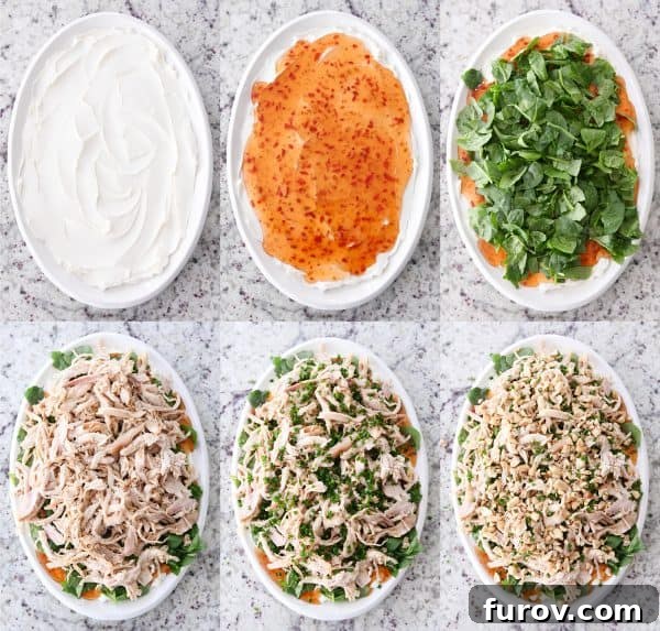 Out-of-this-World Sesame Thai Chicken Dip 4 A visual guide showing the step-by-step layering of the Sesame Thai Chicken Dip: cream cheese base, sweet Thai chili sauce, fresh spinach, shredded chicken, chives, and finally chopped peanuts.