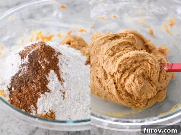 Dry ingredients being gently added to a bowl of creamy pumpkin snickerdoodle batter, illustrating a key step in the recipe.